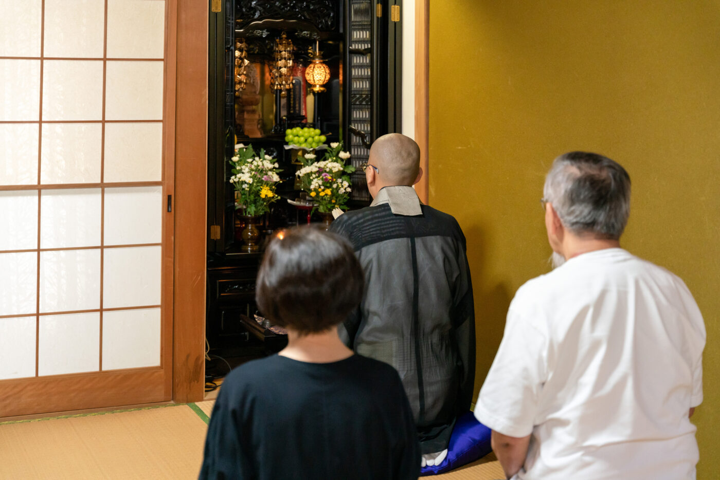 僧侶が自宅で読経する様子